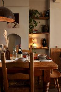 a dining room table with plates and bottles of wine at NEW! Stylish Chester Townhouse, Sleeps 6 in Chester