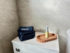 a bottle of makeup sitting on top of a toilet at NEW! Stylish Chester Townhouse, Sleeps 6 in Chester +28 photos