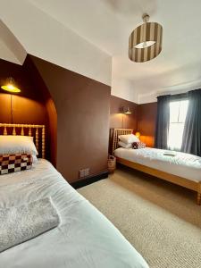 a bedroom with two beds and a window at NEW! Stylish Chester Townhouse, Sleeps 6 in Chester