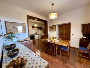 a kitchen and dining room with a table and chairs at Castello Vinci - Dimora di Charme in Vetralla