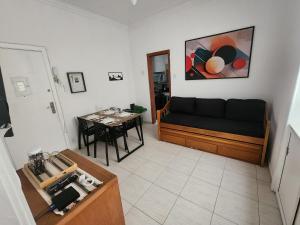 a living room with a couch and a table at Sala e quarto a 1 quadra da praia de Copacabana in Rio de Janeiro