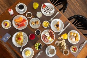 a table with plates of breakfast food on it at Blue Tree Premium Florianópolis in Florianópolis +55 photos