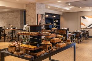 a bakery with a display of food on a table at Blue Tree Premium Florianópolis in Florianópolis