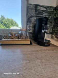 a hair dryer sitting in a room next to a stone wall at MAISON COSY 7 minutes des frontières in Rosenau +10 photos
