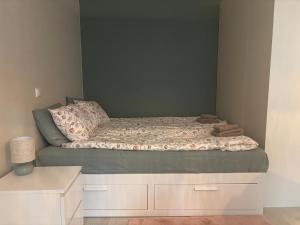 a small bed in a bedroom with a bed frame at Cozy apartment for 2 - free parking in Oulu