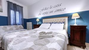 a bedroom with a bed with a sign on the wall at Casetta La Rubiconda in Asti