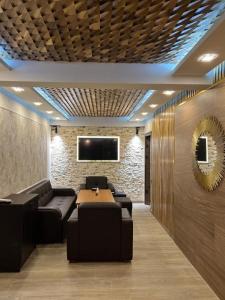 a conference room with a table and chairs and a tv at VIAGGIO Yerevan in Yerevan