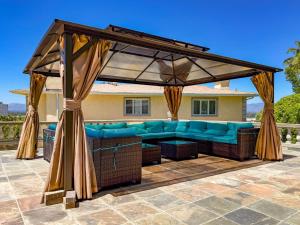 a pavilion with a blue couch under a canopy at Vista Villa – Poolside Elegance with Views in Sherman Oaks