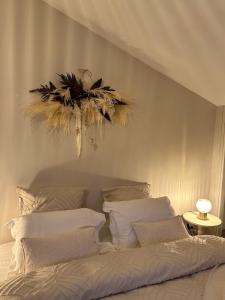 a bedroom with a bed and a chandelier at L'écrin du sancy in La Bourboule