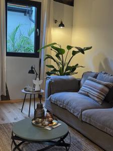 a living room with a couch and a table at EifelQuartier L9 in Schleiden