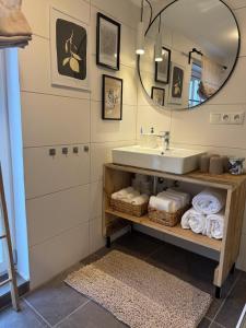 a bathroom with a sink and a mirror at EifelQuartier L9 in Schleiden