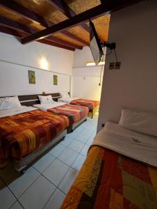 Postel nebo postele na pokoji v ubytování Hana'q Hostel en el Valle sagrado, junto al rió Vilcanota