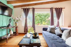 a living room with a blue couch and a window at Quinta San Francisco in Cuernavaca +17 photos