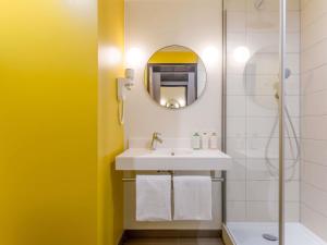 a bathroom with a sink and a shower at ibis Styles Paris Meteor Avenue d'Italie in Paris +84 photos