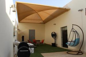 a living room with a patio with a roof at Elite of Elite Hotel Apartments in Riyadh