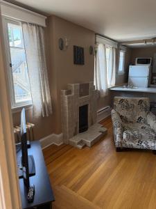 a living room with a couch and a fireplace at Midstream Manor Unit 8 - 2 Bedroom Apartment in St. John's
