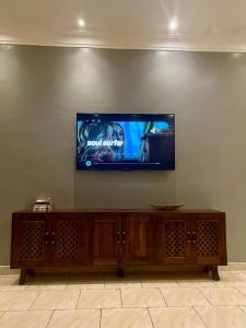a flat screen tv sitting on a wall at The Fancy convenience-free wifi Kyanja in Kampala