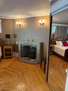 a living room with a fireplace and a bed at Midstream Manor Unit 9 - 2 Bedroom Apartment in St. John's