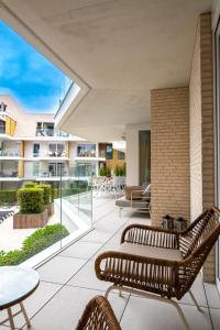 an outdoor patio with two chairs and a table at Sailors' Park Villa Zephir in Nieuwpoort