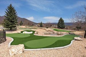 a golf course with a simulation of a green at Comfortable Double Queen Suite Near Park City & Ballerina Farms #1055 in Mound City