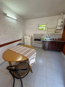 a small kitchen with a table and a refrigerator at Depto 168 in Santa Rosa de Calamuchita