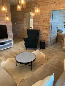 a living room with a couch and a chair and a table at Apartments Panorama Donovaly in Donovaly