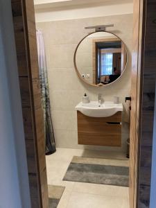a bathroom with a sink and a mirror at Apartments Panorama Donovaly in Donovaly