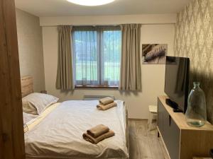 a bedroom with a bed with two towels on it at Apartments Panorama Donovaly in Donovaly +73 photos