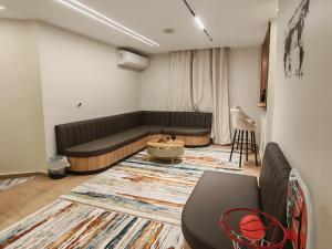 a living room with a couch and a table at Tahrir apartments in Cairo +1 photo