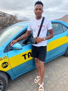 a man standing in front of a car at Taxi driver in Espargos