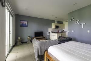 a bedroom with a bed and a living room at Corporate Stays Urban Flats Studio in Lagunilla