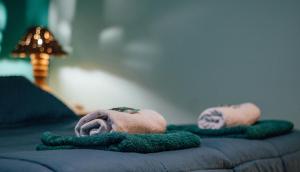 a person laying on top of a bed with towels at Los Airampos in Humahuaca