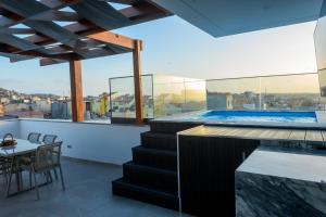 a house with a swimming pool and a table at Yes Rooftop, Private Pool & Sea View, Cidadela in Praia