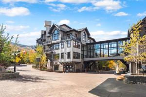 スノーマス・ビレッジにあるElk Camp Cove Snowmass Top-floor Mountain Studioの道路に橋が架かっている大きな建物
