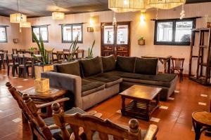 sala de estar con sofá, mesas y bar en Hotel Pastos Chicos, en Susques