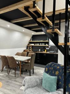 a dining room with a table and chairs at Planinska vila KTM Lisine in Despotovac