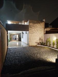 an empty house with a garage at night at Sobrado São Chico, Ubatuba SFS in São Francisco do Sul