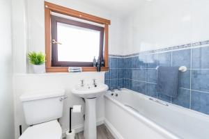 a bathroom with a sink and a tub and a toilet at Boddam getaway - CMC Stays in Boddam +36 photos