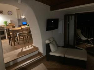 a living room with a couch and a dining room at Nina's House , nonna Lucia in Badolato