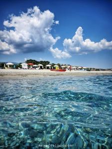 a body of water with a beach with tents at Nina's House , nonna Lucia in Badolato