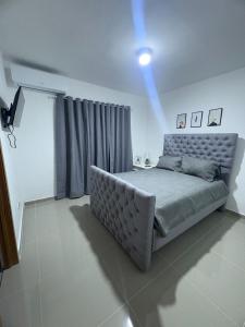 a bedroom with a bed with a blue light on it at Apartamento amplio con piscina  +15 photos