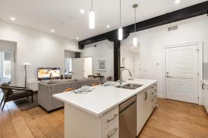 an open kitchen and living room with a couch at The Saddlery - Headliner - Walk to Broadway in Nashville