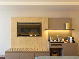 a room with a kitchen with a counter and a counter top at Palladio Hotel Buenos Aires - MGallery Collection in Buenos Aires +188 photos