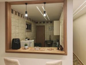 a mirror on the wall of a kitchen with a table at Tahrir apartments in Cairo