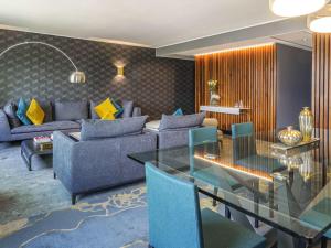 a living room with couches and a glass table at Pullman Santiago Vitacura in Santiago