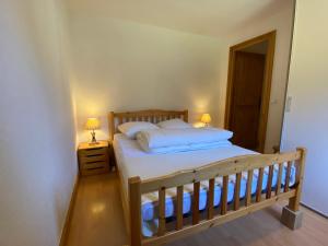 Ένα ή περισσότερα κρεβάτια σε δωμάτιο στο Appartement 4-6 personnes centre Les Contamines Montjoie