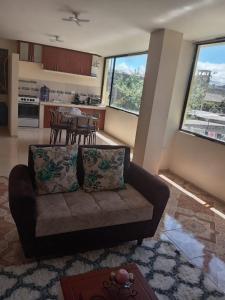 a living room with a couch and a table at Entire apartment in Ambato Ficoa in Ambato
