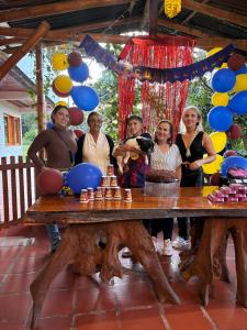 a group of women standing around a table with a chess game at CABAÑA LOS NOGALES in San Agustín +211 photos