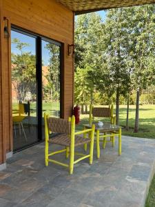 a patio with a yellow bench and a table at Villa Sofia And Spa in Marrakech