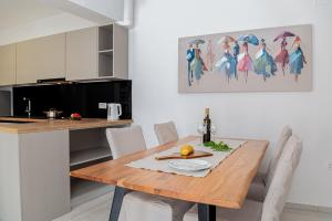a kitchen and dining room with a wooden table at Haus Quadro in Rabac